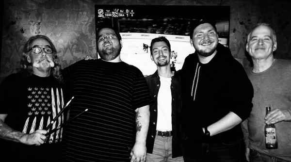 Black and white picture of our New York rock country cover band smiling happily for camera at private event | Altus Entertainment